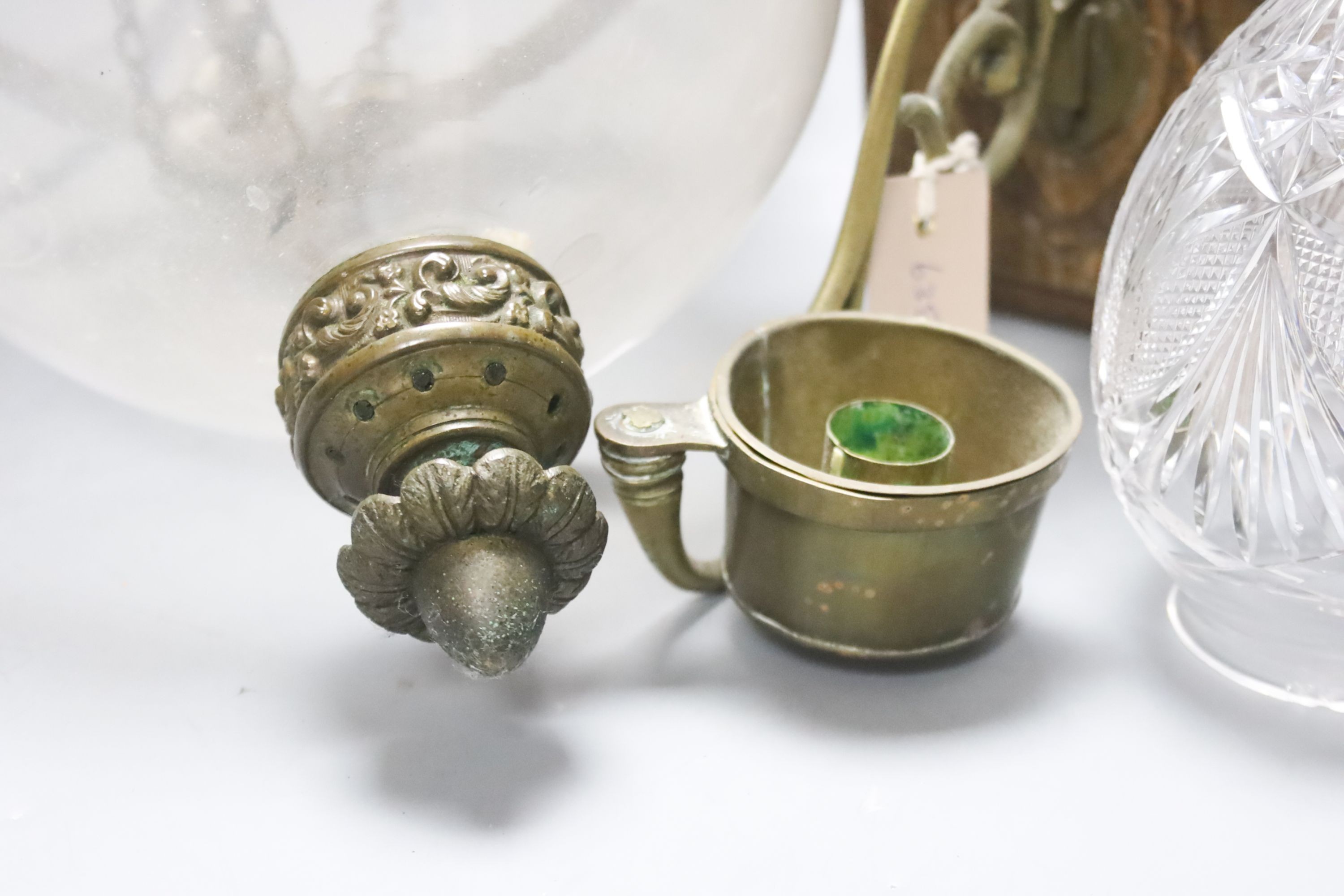 A Dutch carved wood and brass wall candle holder and a hanging glass lantern with cover